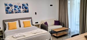a hotel room with a bed and a chair at Parga kamara studio in Parga