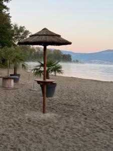 an umbrella on a sandy beach with at Studio yvonand in Yvonand