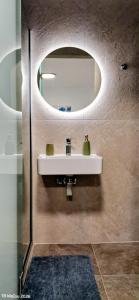 a bathroom with a sink and a mirror at Parga kamara studio in Parga +36 photos