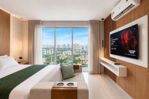 a hotel room with a large bed and a large window at The Expression Building - Setor Bueno - THP in Goiânia +291 photos