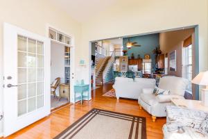 a living room with white furniture and a staircase at Bayview Landing - 38013 Bayview Circle in Selbyville