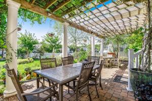 a patio with a table and chairs under a pergola at Bayview Landing - 38013 Bayview Circle in Selbyville