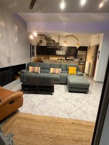 a living room with a couch and a kitchen at Zoza Luxury villa isthmia by the sea with private pool in Kalamáki