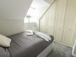 a bedroom with a bed with white towels on it at 9 Beckett Close in Colwyn Bay
