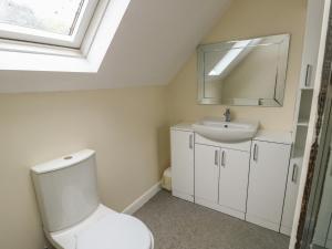 a bathroom with a white toilet and a sink at 9 Beckett Close in Colwyn Bay +27 photos