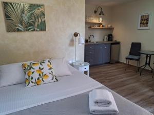 a bedroom with a bed and a table and a kitchen at Terra Solaris Guesthouse in Kissamos +90 photos