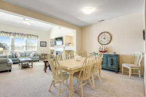 a dining room and living room with a table and chairs at Bear Trap Dunes - 60F October Glory in Ocean View