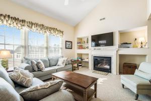 a living room with a couch and a fireplace at Bear Trap Dunes - 60F October Glory in Ocean View