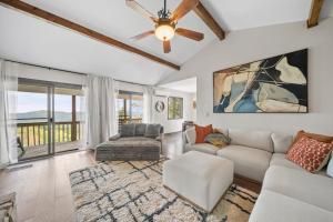 a living room with a couch and a ceiling fan at Mountain Sunrise in Blowing Rock