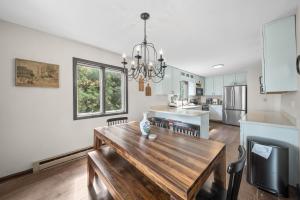 a kitchen and dining room with a wooden table at Mountain Sunrise in Blowing Rock