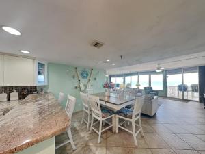 a kitchen and dining room with a table and chairs at Oceanside Retreat 804 in Ormond Beach