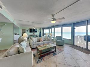 a living room with a couch and a table at Oceanside Retreat 804 in Ormond Beach