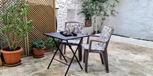 a black table and two chairs on a patio at Parga kamara studio in Parga