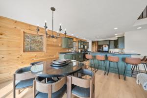 a dining room with a table and chairs in a kitchen at Sugar View Chalet in Banner Elk