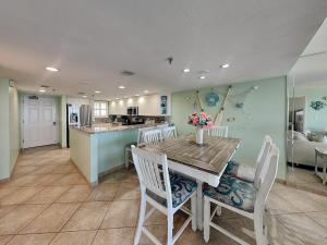 a kitchen and dining room with a table and chairs at Oceanside Retreat 804 in Ormond Beach
