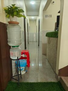 a hallway in a hospital with a plant in a bucket at Beaumun Homestay in Bāghdogra