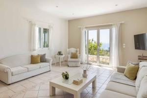 a living room with a couch and a table at Villa Mihas in Vlachata