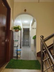 a hallway with an archway with a plant on it at Beaumun Homestay in Bāghdogra