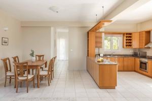 a kitchen and dining room with a table and chairs at Villa Mihas in Vlachata