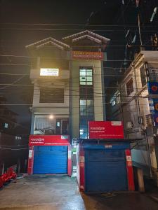 a building with blue and red doors in front of it at Beaumun Homestay in Bāghdogra