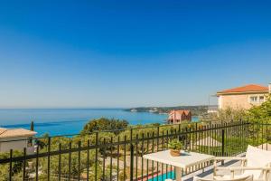 a view of the ocean from the balcony of a house at Villa Mihas in Vlachata