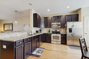 a kitchen with wooden cabinets and stainless steel appliances at Rehoboth Crossing --- 36985 Grindstone Ln in Rehoboth Beach +21 photos