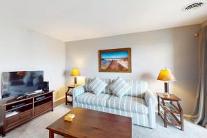 a living room with a couch and a tv at Rehoboth Beach -- The Crest #303 in Rehoboth Beach