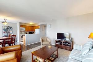 a living room with a couch and a table at Rehoboth Beach -- The Crest #303 in Rehoboth Beach