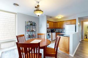 a kitchen and dining room with a table and chairs at Rehoboth Beach -- The Crest #303 in Rehoboth Beach