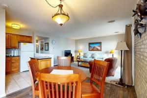 a kitchen and living room with a table and chairs at Rehoboth Beach -- The Crest #303 in Rehoboth Beach +26 photos