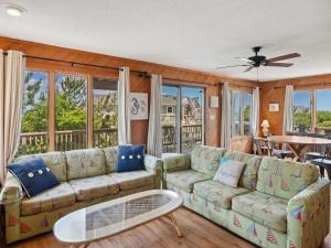a living room with a couch and a table at 2030 - Horizon`s Summit in Duck