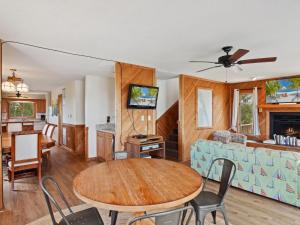 a living room with a table and a couch at 2030 - Horizon`s Summit in Duck