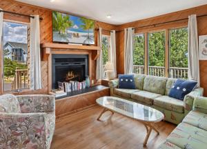 a living room with a couch and a fireplace at 2030 - Horizon`s Summit in Duck