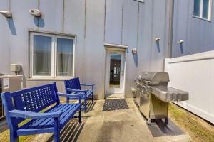a patio with two blue benches and a grill at Rehoboth Beach --- Forj Lofts, Unit #2 in Rehoboth Beach