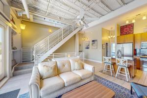 a living room with a couch and a staircase at Rehoboth Beach --- Forj Lofts, Unit #2 in Rehoboth Beach