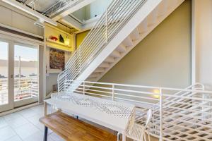 a white staircase in a room with a bench at Rehoboth Beach --- Forj Lofts, Unit #2 in Rehoboth Beach +21 photos