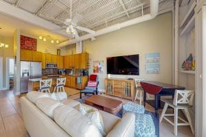 a living room with a white couch and a kitchen at Rehoboth Beach --- Forj Lofts, Unit #2 in Rehoboth Beach