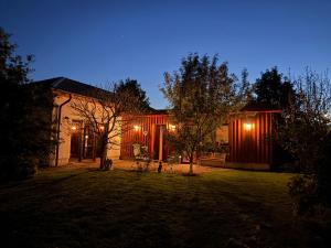 a house with lights on the front of it at night at Ferienwohnung Lahost in Lahošt
