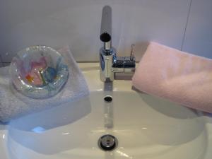 a bathroom sink with a towel and a soap dispenser at Ferienwohnung-VS in Villingen-Schwenningen