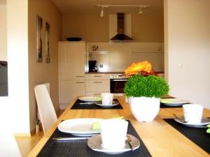 a kitchen with a wooden table with a dining room at Ferienwohnung-VS in Villingen-Schwenningen