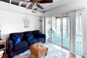 a living room with a blue couch and a ceiling fan at Mallard Lakes -- 38243 Cardinal #115 in Selbyville
