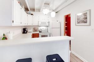 a kitchen with white cabinets and a counter with stools at Mallard Lakes -- 38243 Cardinal #115 in Selbyville +26 photos