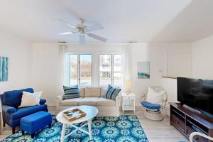 a living room with a couch and a tv at Hidden Harbour -- 306 Ocean View Parkway in Bethany Beach