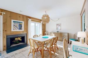a dining room with a table and a fireplace at Hidden Harbour -- 306 Ocean View Parkway in Bethany Beach