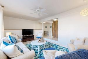 a living room with two couches and a tv at Hidden Harbour -- 306 Ocean View Parkway in Bethany Beach