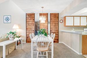 a kitchen and dining room with a white table and chairs at Sea Colony - 802 Wimbledon in Bethany Beach