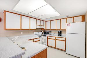 a kitchen with white appliances and a white refrigerator at Sea Colony - 802 Wimbledon in Bethany Beach