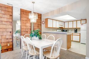 a kitchen and dining room with a white table and chairs at Sea Colony - 802 Wimbledon in Bethany Beach