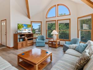 a living room with two couches and a table at 4160 - Shipley in Kitty Hawk