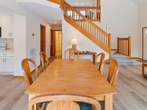 a kitchen and dining room with a wooden table and chairs at 4160 - Shipley in Kitty Hawk